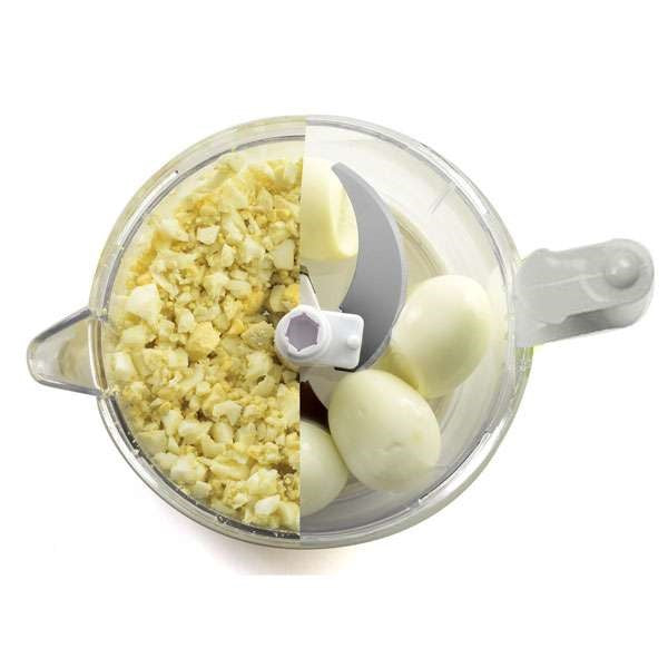 top view of best rated food chopper with half chopped boiled eggs and half whole boiled eggs