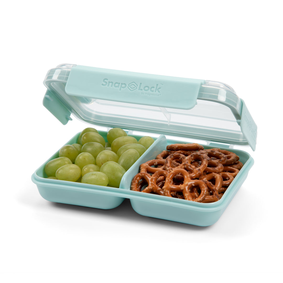 light blue plastic food storage container for snacks and lunch with open lid and a divider separating green grapes and pretzels