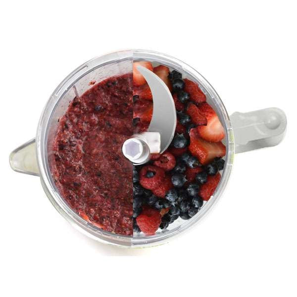 top view of good rated food chopper with half blended fruit and half whole berries