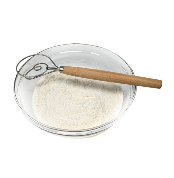 Norpro 12'' Danish Dough Whisk sitting on top of mixing bowl with dry ingredients inside