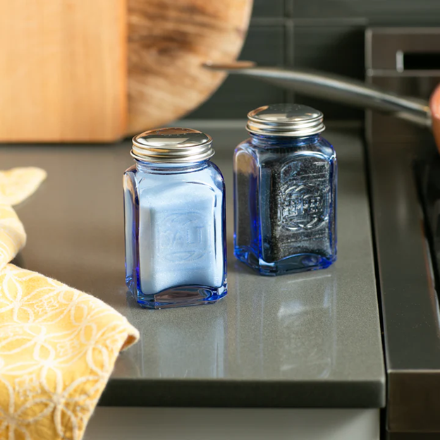 blue glass vintage salt and pepper shakers with salt and pepper inside in kitchen