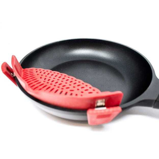 closeup view of red silicone clip on strainer on black stainless pan