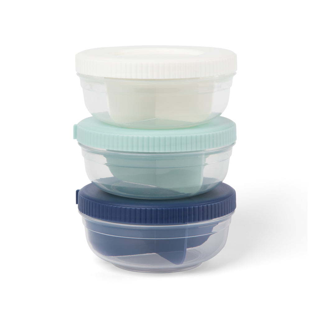 three plastic stackable food storage snack containers stacked on top of each other, in navy, mint, and white colors